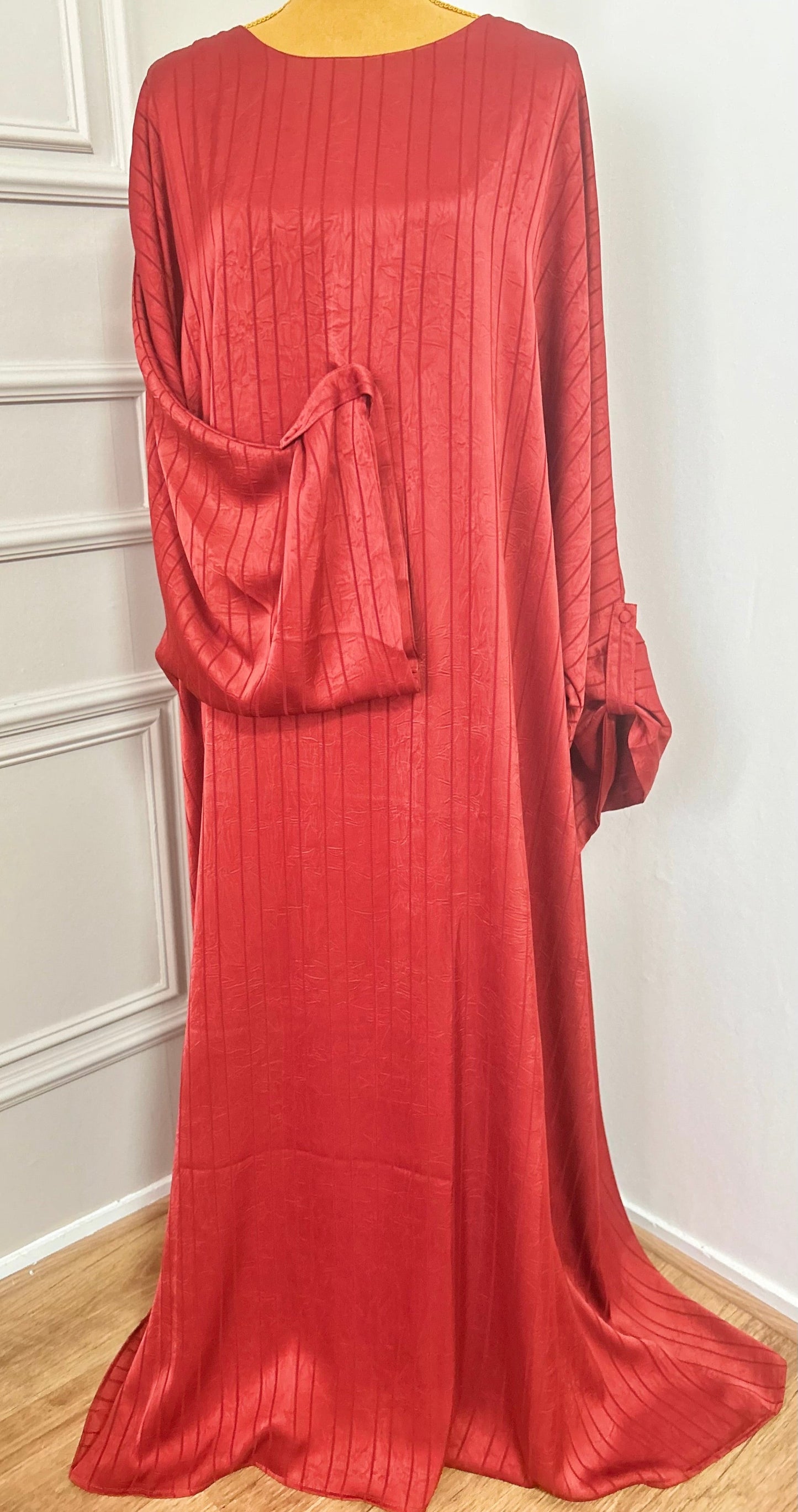 Abaya satinée bordeau pour femme, coupe longue et fluide, tissu texturé, manches longues, col rond.