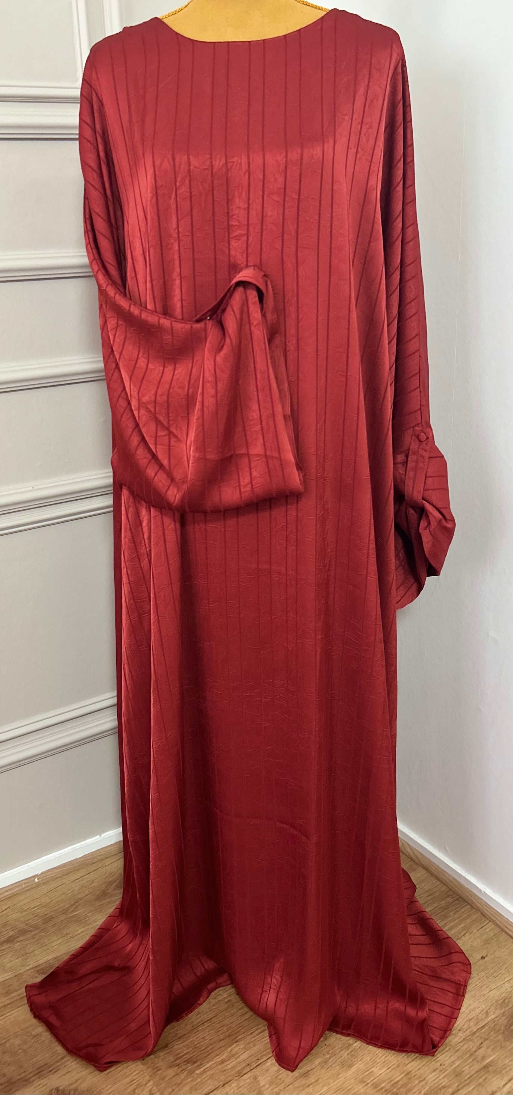 Abaya satinée bordeau pour femme, coupe longue et fluide, tissu texturé, manches longues, col rond.